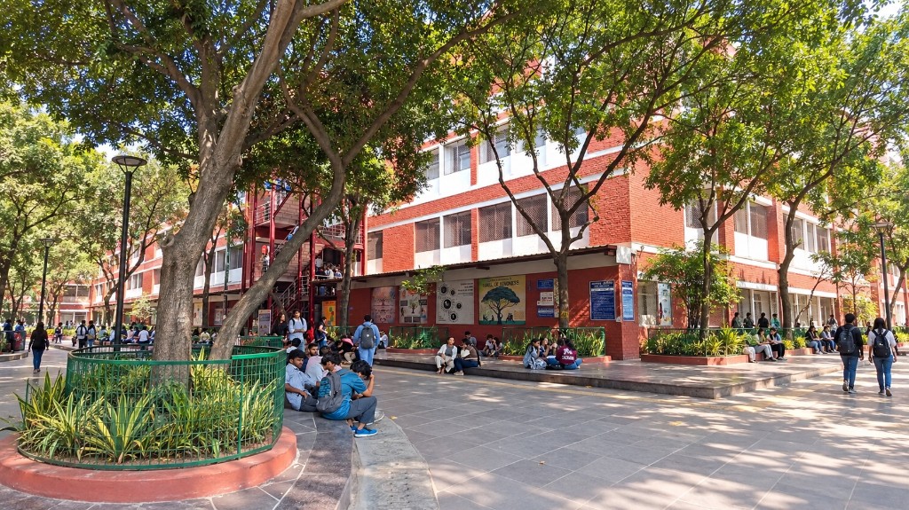 Students gathered in a college campus courtyard between classes